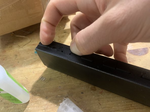 While holding the follower down, gently snap the top locking tab down. Hold it for a minute so the glue can set.