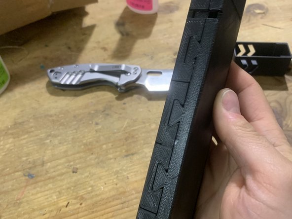 Moving towards the bottom of the mag, glue each tab one by one. Allow each tab to set before moving on.