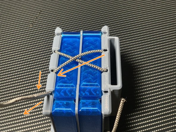 Pull one end of the cord diagonally across, thread upwards, and pull through the second hole from the top.