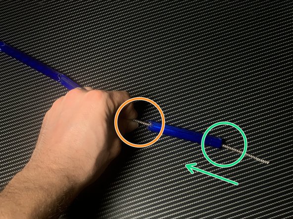 Pinch and hold the cord where it leaves the rod segment.