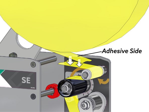 Stick the end of the new tape roll onto the tape remaining in the feed rollers.