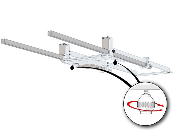 Loosen the the two ball knobs securing the mandrel trolley,