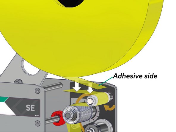 Stick the end of the new tape roll onto the tape remaining in the feed rollers.