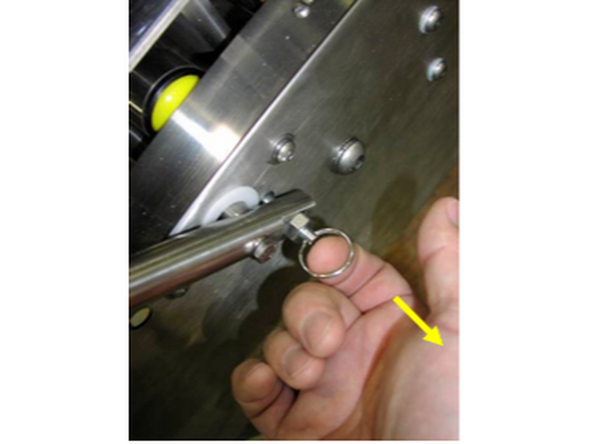 4-To lower the bottom head back down into the machine frame, use the lever to take the weight of the head and pull the latch pin out to release the lever arm.