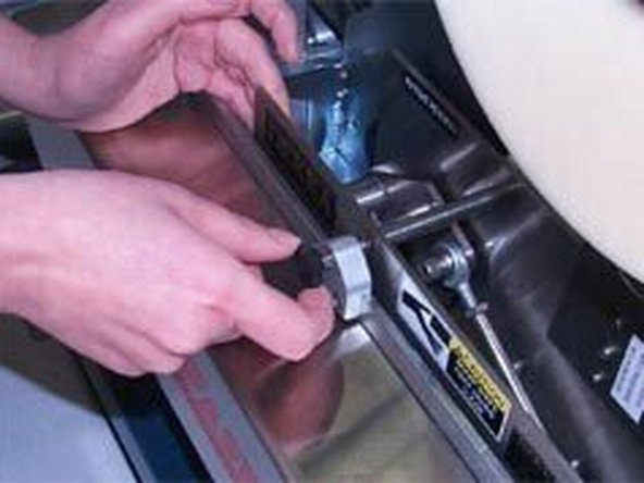 2-Lower the tape head into the holder while aligning the tape head pins to the slots. Push to slide the tape head toward the rear of machine to lock it in place.