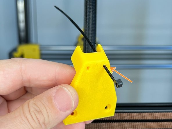 Insert a Zip Tie on the slot of the cable harness support part.