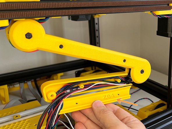 Find the part labelled as Z04 to cover the arm and use two M3 x 22 mm Screws to affix.