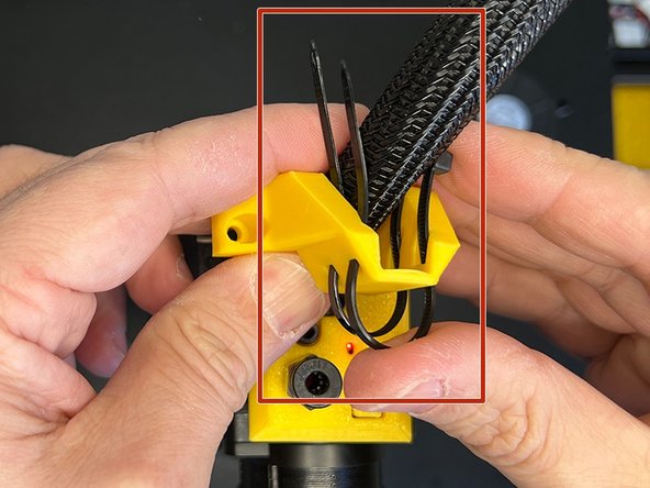 Tuck in the cable sleeve between the zip ties.