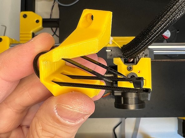 Insert the zip ties through the other two slots in the front.