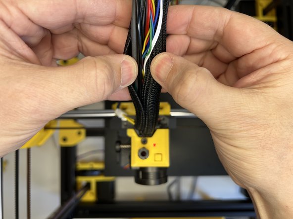 Insert the 3mm nylon filament and tuck the cable harness in the cable sleeve.