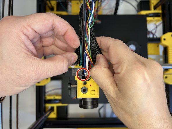 Insert the 3mm nylon filament and tuck the cable harness in the cable sleeve.