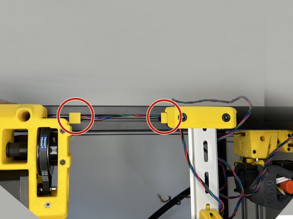 Tuck in the Z Motor 2 cable by using the 3030 cable clips. Pass the cable under the DIN Rail Holder and push the clip in.