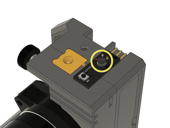 Push the ball housing into the slot on top of the extruder assembly.