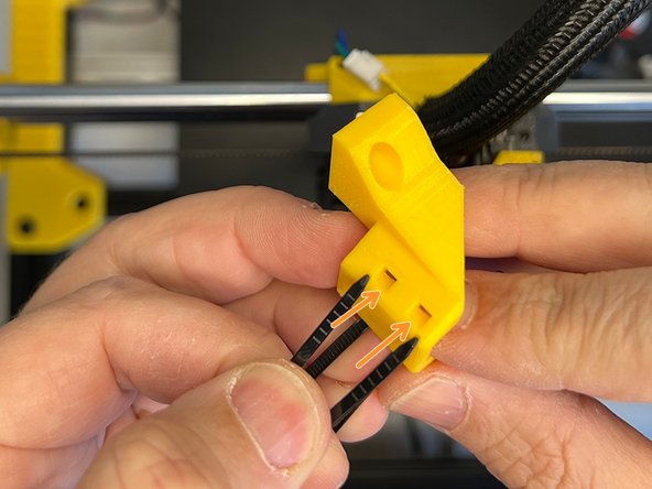 Insert the zip ties through the other two slots in the front.