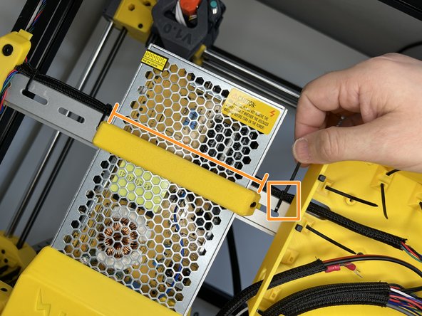 Pass the sleeve under the PSU. Squeeze the cable sleeve in between the PSU and DIN rail eave and affix it with a zip tie.