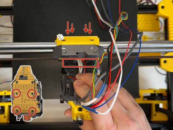 Insert four M3 x 22 mm Screws from the backside of the X carriage and while holding the cable harness, align the bottom two screws with the holes on the extruder body and screw those two bottom screws first. Ensure that the cables are aligned with the vertical harness gap.