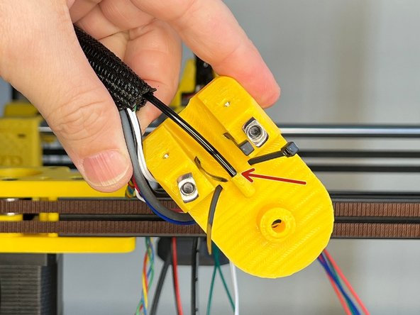 Insert the 3mm Nylon Filament's end into the hole on the Z Lift's top part.