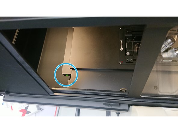 Gently tilt back the transmitted light arm  for easier access to the stage.