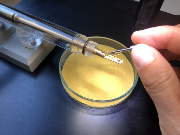 Use non magnetic forceps. Use a stereo microscope for better visibility.