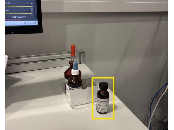 Put a drop of the immersion on the objective/sample (bottle on the table).