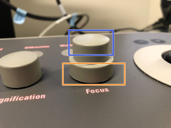 Turn the upper part of the  Focus knob on the right panel to stop the image movement