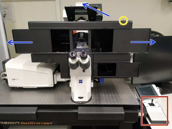 Push back the condenser arm and open the upper doors.