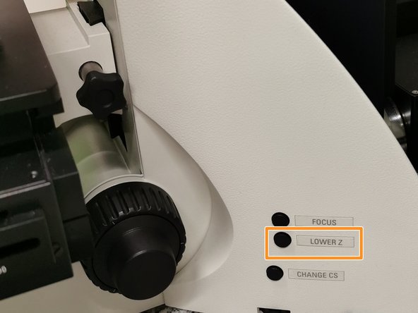 Lower the stage by pressing the &quot;LOWER Z&quot; button on the right side of the microscope.
