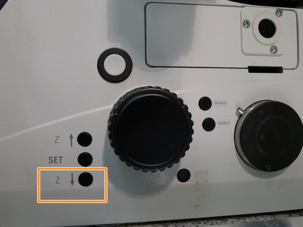 Lower the objective turret by pressing the downwards &quot;Z&quot; button on the right side of the microscope.