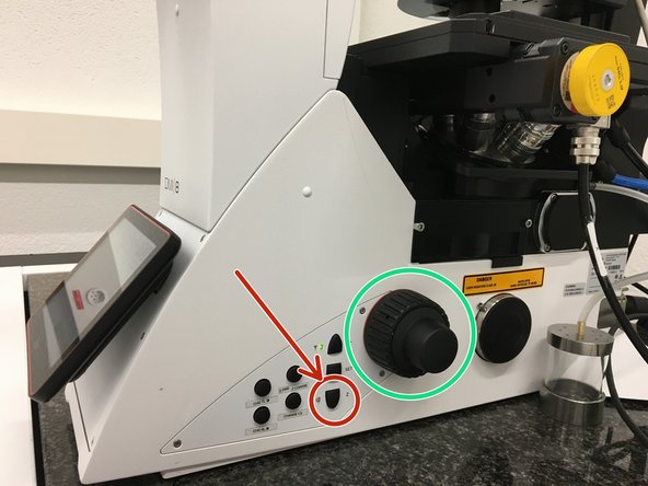Lower the objective by keeping the &quot;LOWER Z&quot; button pressed on the right side of the microscope.