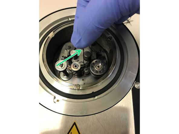 Put the carbon filament in your fingers and mount it through the loop. Precisely explained in step 12.