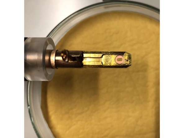 Open the holder clamp with the supplied needle