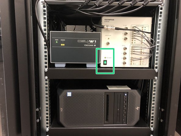 Open the door of the rack on the left of the microscope.