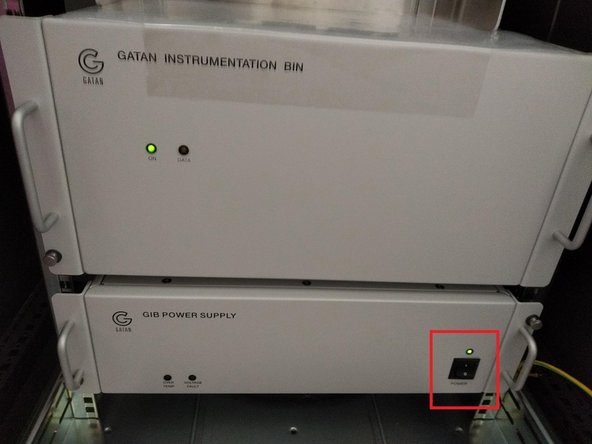 Open it with the key that is on top of the rack.