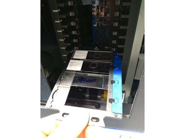 Hold carrier by the handle with the slice labels facing upwards.