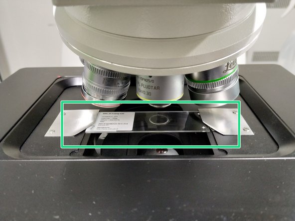 Slide your sample into place with the coverslip facing up .