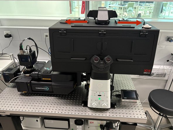 Open the top covers and lean back the condenser arm to access the stage.