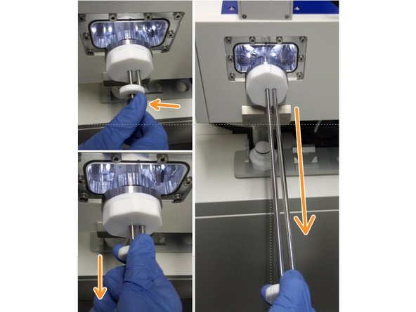 Use the white piece at the far end of the rod to slowly insert the sample holder into the microscope.