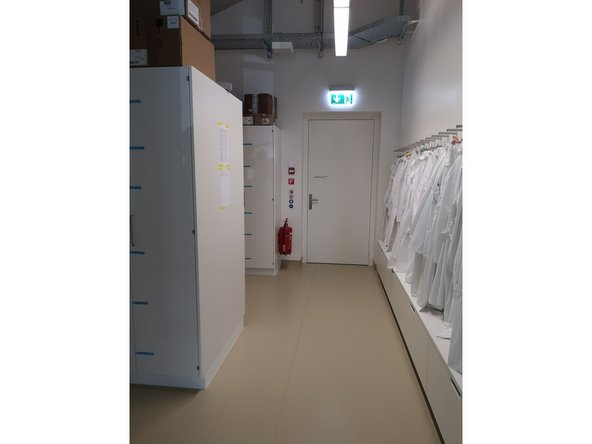 Proceed straight ahead and enter the door “Auxiliary Lab V.244”. Turn left and use the stairs to go half a floor down.