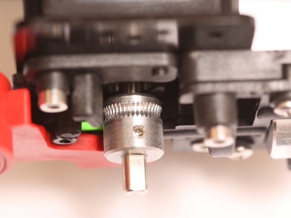 Line up the center of the knurling pattern with the center of the ball bearing.  Note the orientation of the pulley.  Tighten the set screw down onto the flat of the stepper motor shaft.
