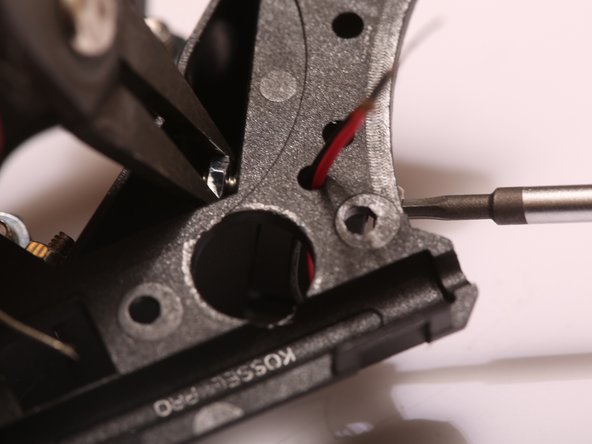 Thread thee red and black cable through the small hole on the end effector top housing.