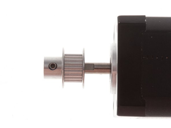 Place the component stackup as shown and press pulley on, keeping care to align set screw over flat on motor shaft