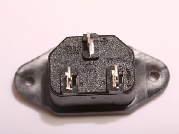 This is the IEC power inlet.  IEC is an international standard set forth by the ISO governing power cords for various telecommunications instruments and devices.