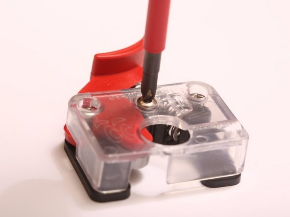 With a #1 Phillips screwdriver, remove the single #1 Phillips drive screw from the SeeMeCNC EzStruder Top.