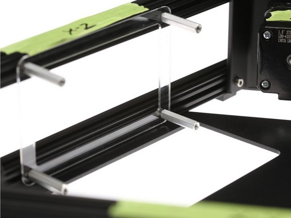 Place the &quot;Clear license plate holder&quot; part over the hex head cap screws to align the screws.