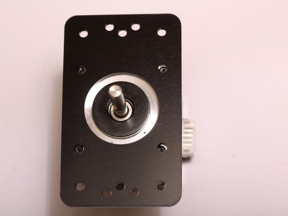 Place an OpenBeam NEMA17 motor bracket onto a stepper as shown.