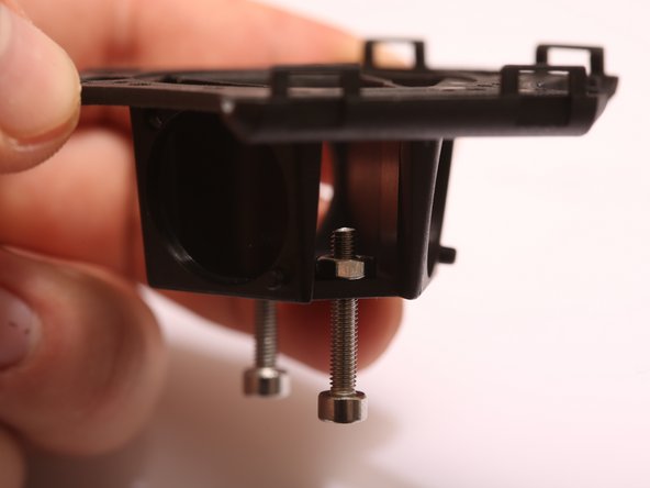 Thread 2x M3 x 18mm SHCS through the top of the end effector, and secure with M3 nuts, threading the screw 3-4 turns past the nut to ensure that it will not fall out accidentally.