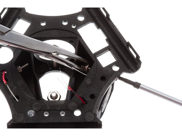 Thread thee red and black cable through the small hole on the end effector top housing.